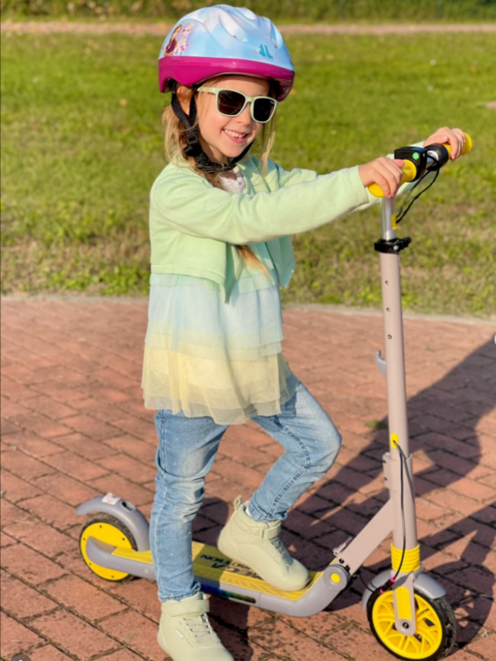 Image of a girl riding a yellow ME1 electric scooter